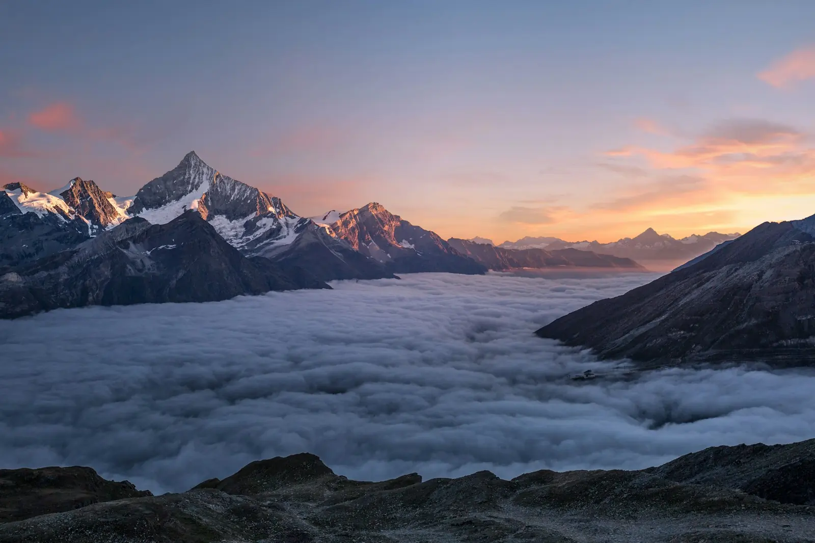 High peaks rising above a sea of cloud