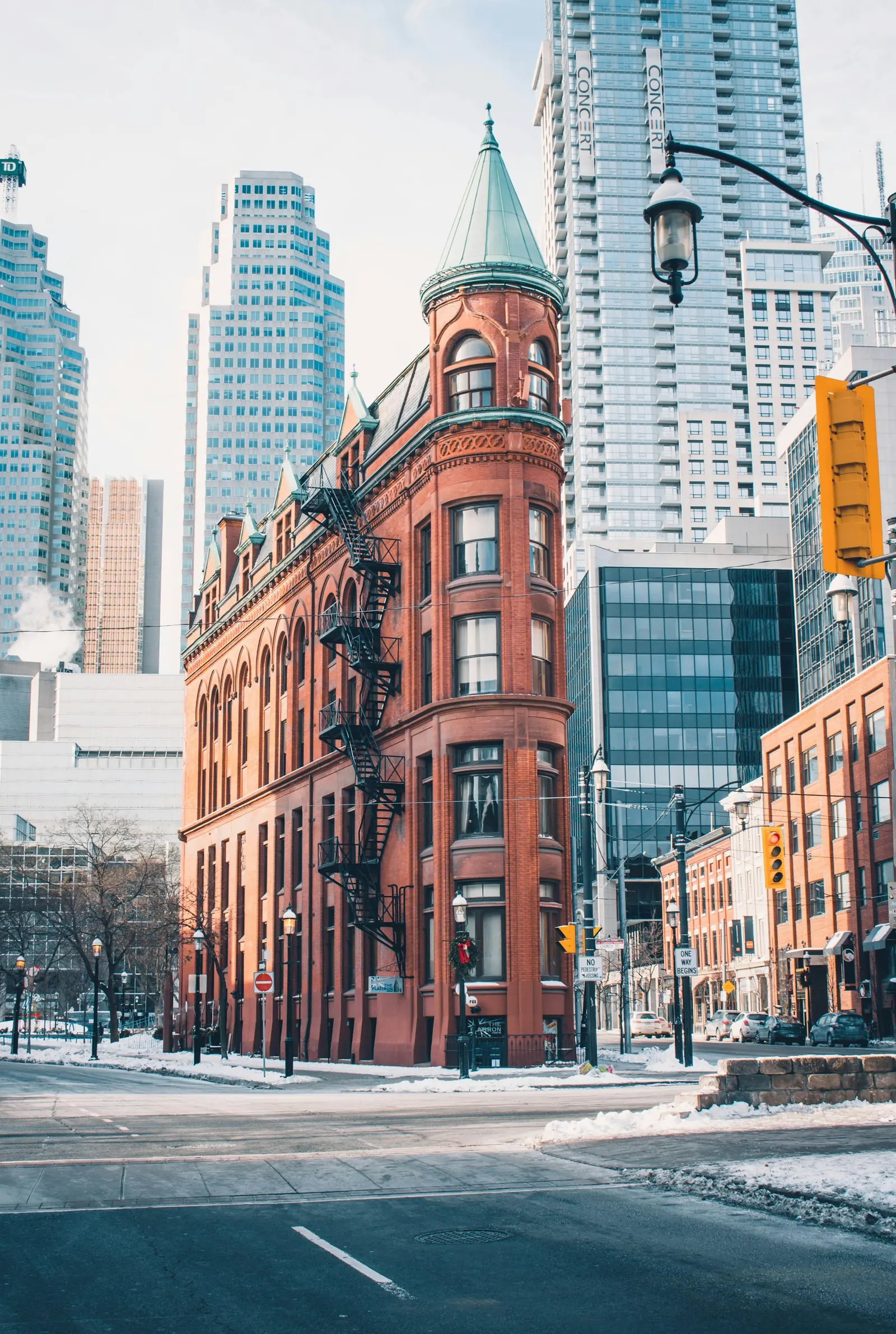 A winter downtown street of brick towers and a historic flatiron building