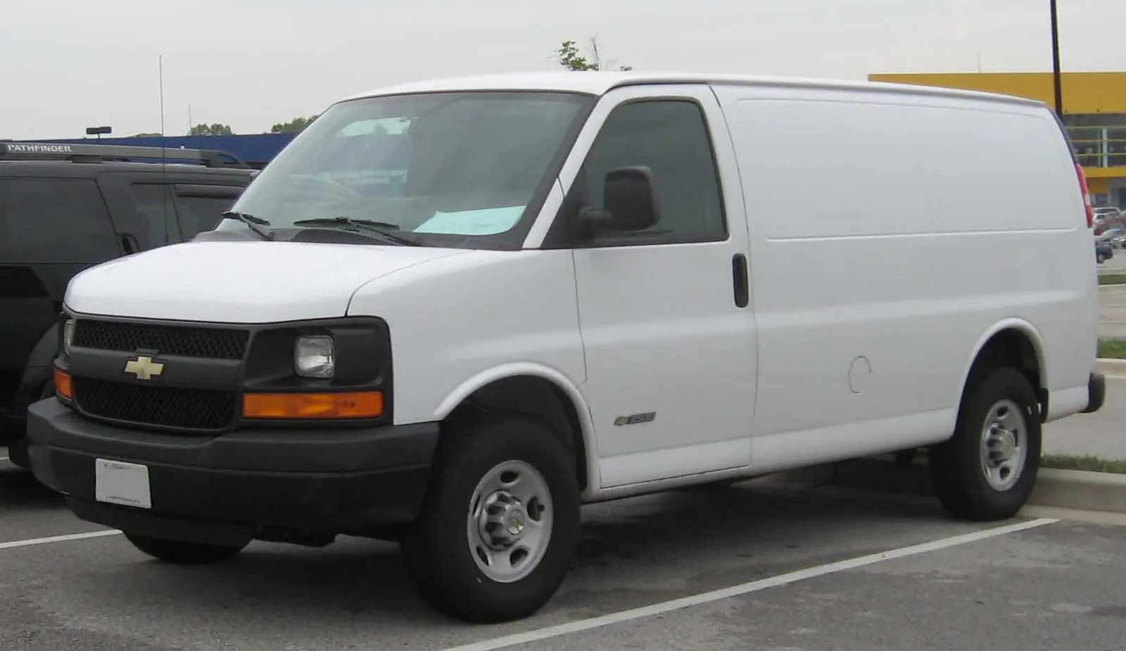 A white cargo van with panel sides and no rear seats in view