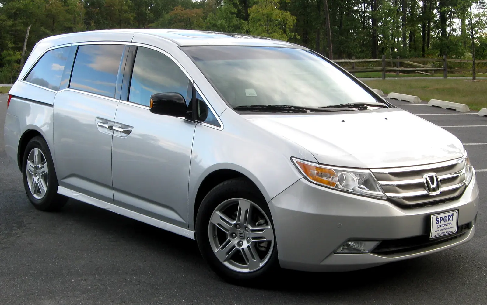 A silver minivan parked in a lot, shown as an example rather than a vehicle for hire